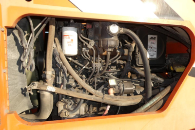 JLG 8042 engine bay showing hydraulic reservoir, hoses, and engine components.