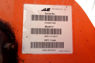 JLG 8042 telescopic boom lift serial label showing Serial No. 0160067960, Model 8042 Legacy, UPC Code, barcode, and sticker text.