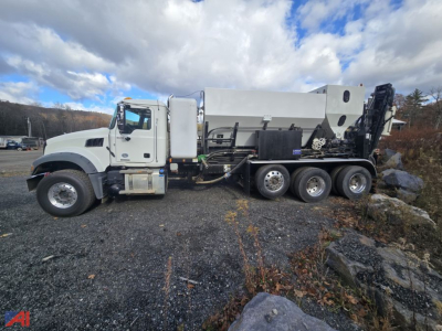 Mack Granite GR64F volumetric mixer truck side view showing mixer drum and hydraulic components.