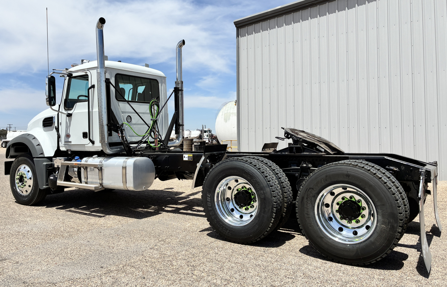 Mack GR64FT conventional daycab truck cab and chassis with dual rear axles parked outdoors