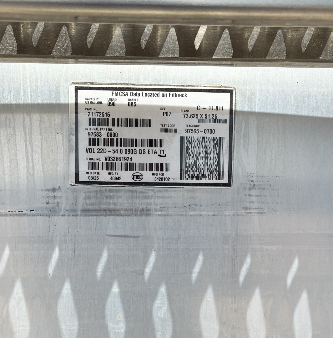 Mack GR64FT engine bay label showing FMCSA data and VIN sticker with barcode.