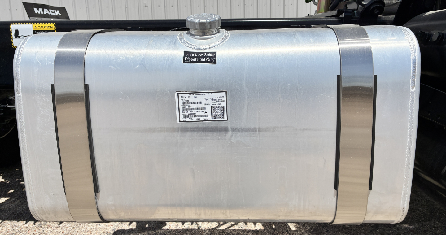 Aluminum fuel tank showing caps and identification label on Mack GR64FT truck