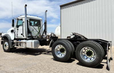 Mack GR64FT conventional daycab truck cab and chassis with dual rear axles parked outdoors