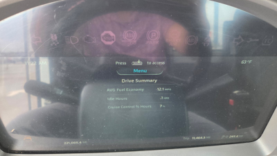 Instrument cluster display of a 2022 Kenworth T880 dashboard showing menu options and engine data, including drive summary with fuel economy and hours.