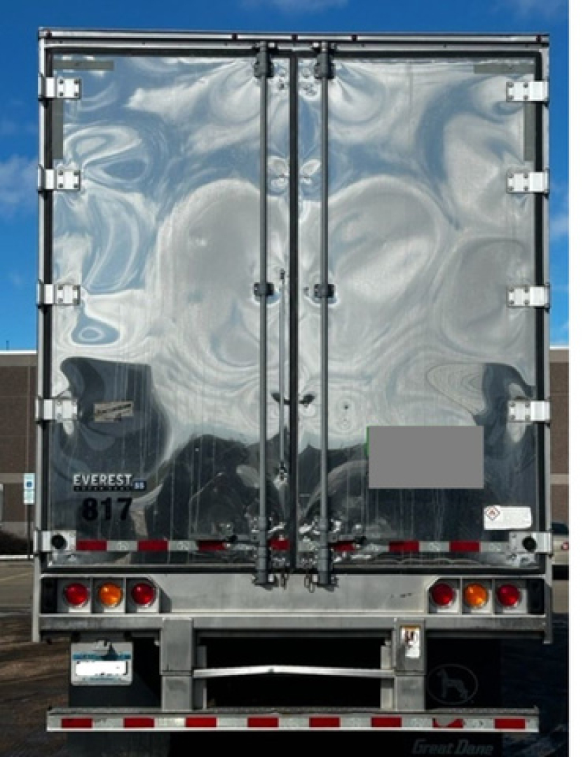 Great Dane reefer trailer rear view with reflective doors, dual rear doors, rear bumper, lights, and Everst? 817 badge.
