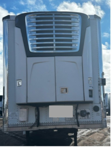 Reefer trailer front view showing cooling unit and lower access panels with grille, vents, and hydraulic lines.