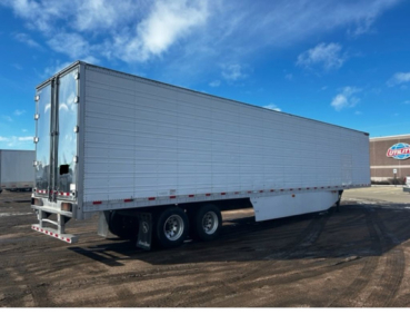 Great Dane reefer trailer with silver exterior and tandem axles, side and rear doors closed.