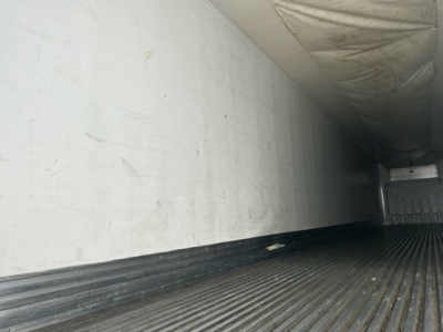 Reefer trailer interior showing ribbed floor and sidewalls of a refrigerated trailer
