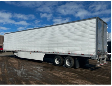 Great Dane reefer trailer side view showing aluminum refrigerated trailer with tandem axles and rear doors.