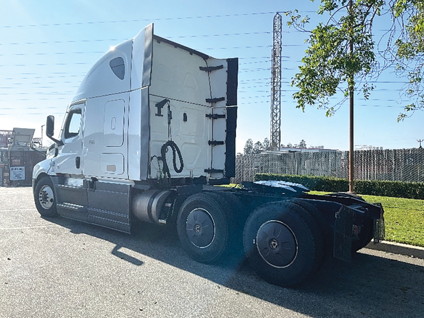 Freightliner Cascadia126 truck tractor side view showing sleeper cab and rear axles.