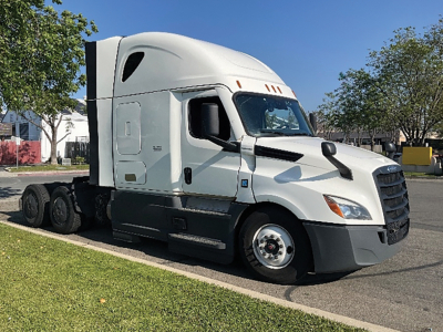 Truck cab showing clean white Freightliner Cascadia 126 sleeper with aerodynamic hood and dual rear axles.