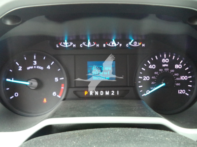 Instrument cluster of a 2021 Ford F650 showing gauges, central digital display, and PRNDM21 gear indicator.