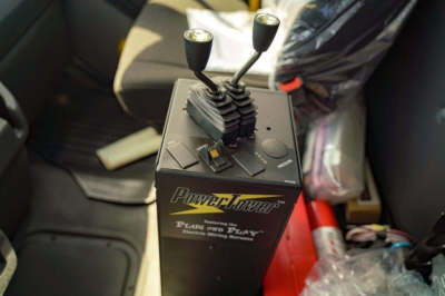 Freightliner 114SD cab interior showing PowerLifter control box with two joystick levers and labeled switches.