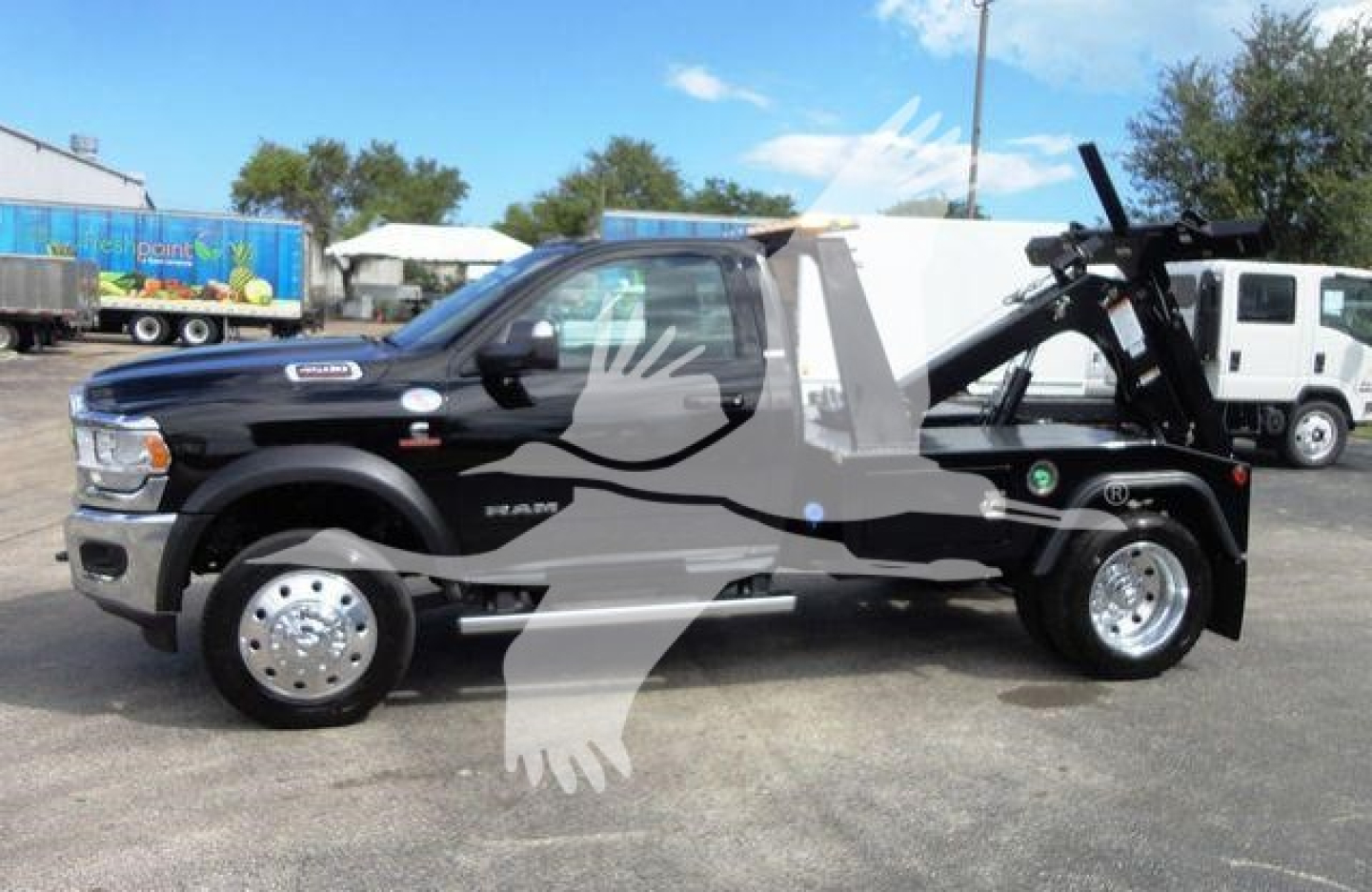 Ram 4500 tow truck with winch attachment and black body, side view showing front wheels and cab, stock number J86261.