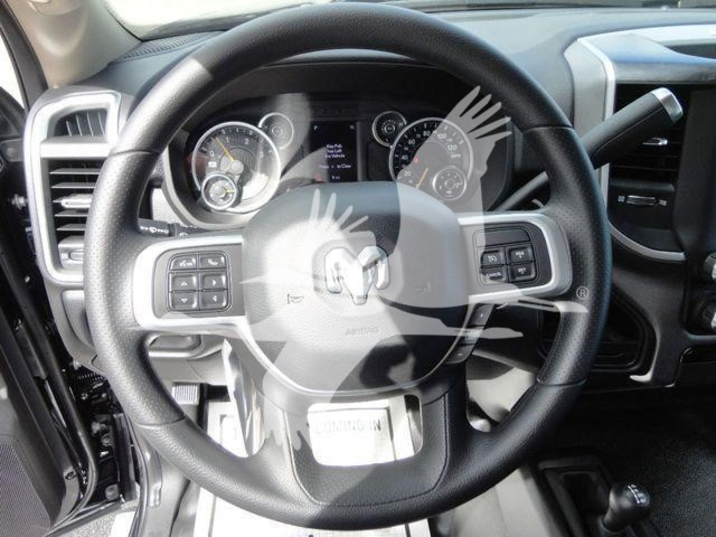 Ram 4500 interior showing steering wheel with mounted controls and instrument cluster View of dashboard and center area.