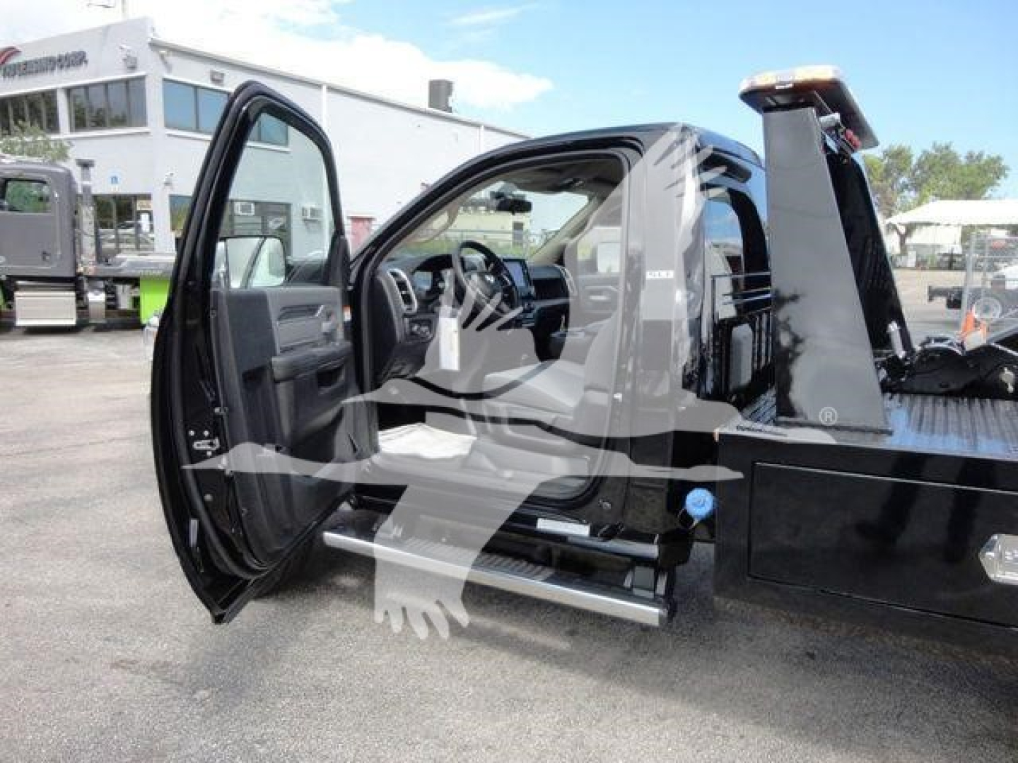 Ram 4500 SLT cab interior and open door showing side step and part of winch-equipped flatbed truck.