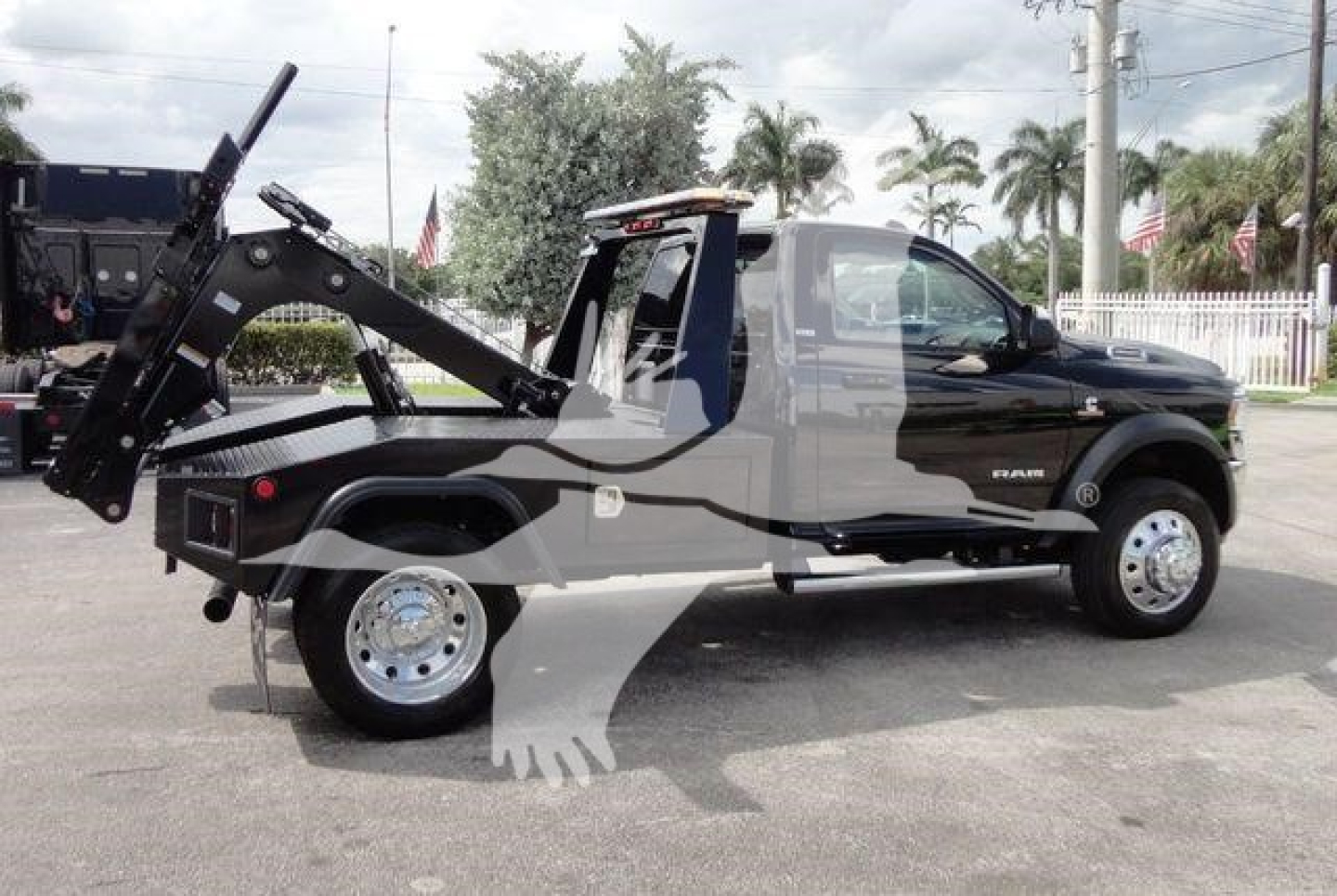 Ram 4500 SLT tow truck with industrial winch and heavy-duty rear deck showing winch mount and hydraulic lines.
