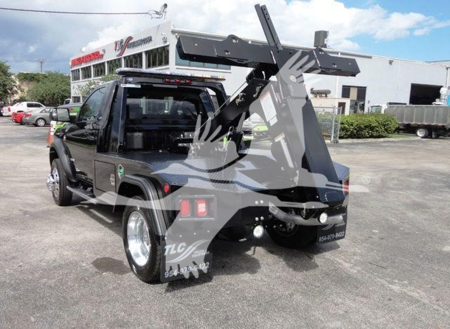 Ram 4500 SLT pickup with a mounted heavy-duty tow winch and crane arm in a rear three-quarter view.