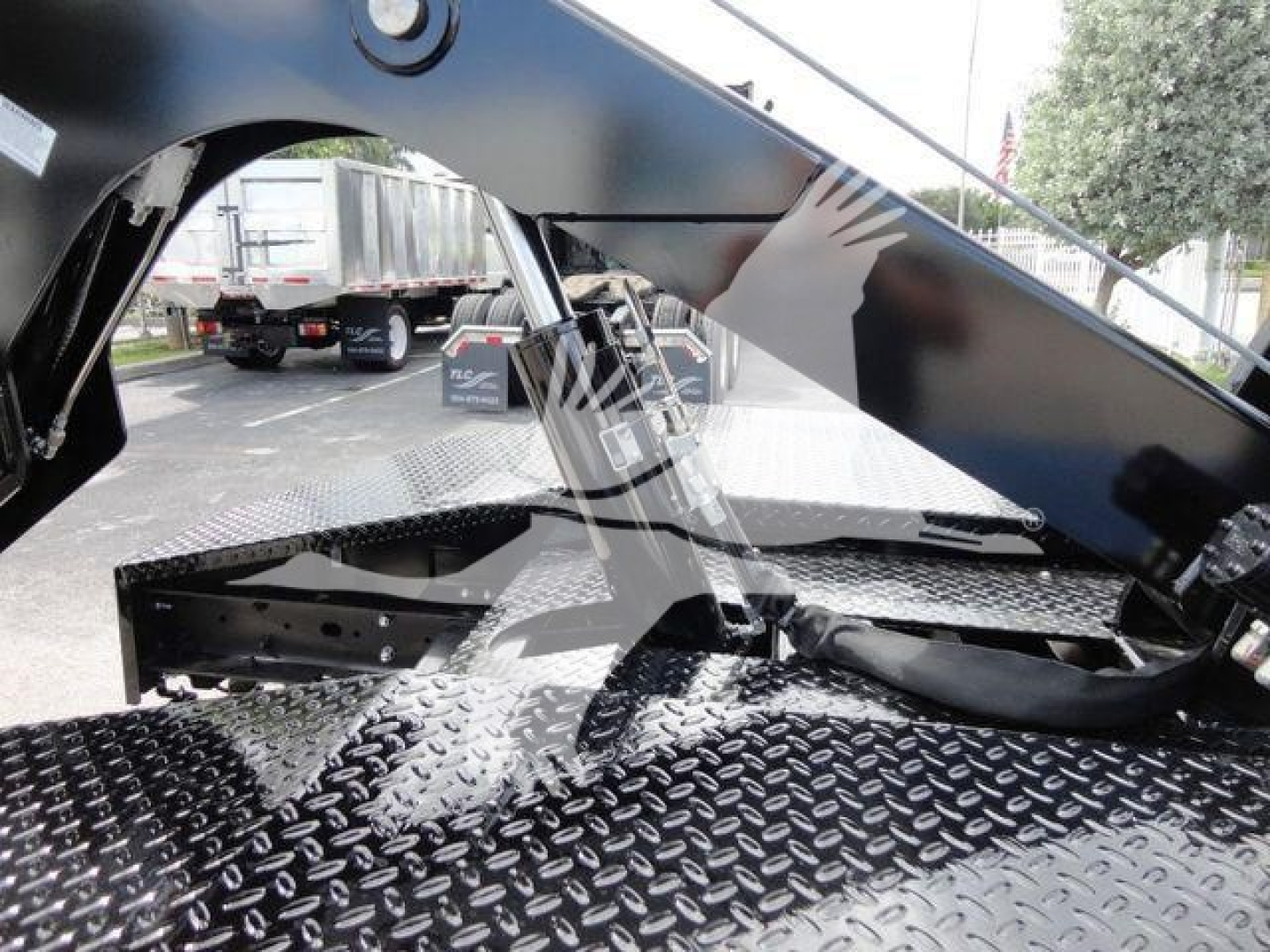 Ram 4500 SLT winch truck rear deck with hydraulic winch mount and diamond plate surface visible.