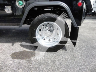 Truck wheel and fender of a 2024 Ram 4500 SLT showing chrome wheel, tire, and black fender flare.