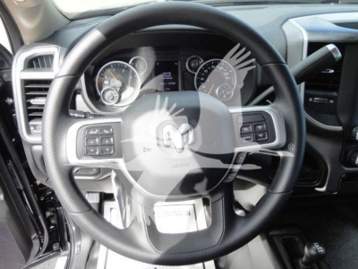 Ram 4500 interior showing steering wheel with mounted controls and instrument cluster View of dashboard and center area.