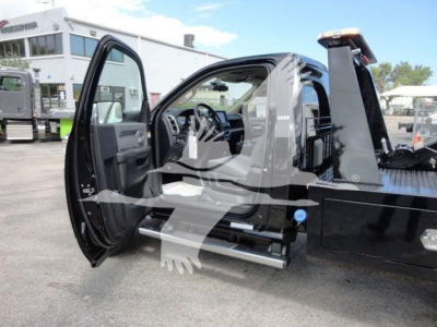 Ram 4500 SLT cab interior and open door showing side step and part of winch-equipped flatbed truck.