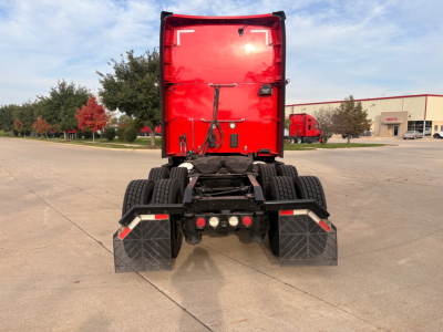 Kenworth T680 rear view showing chassis, dual rear axles, and mud flaps.