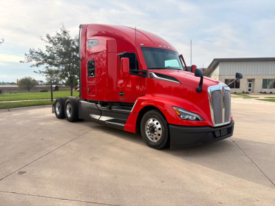 Kenworth T680 tractor-trailer in red, side view showing front grille, aerodynamic sleeper cab, and dual rear axles.
