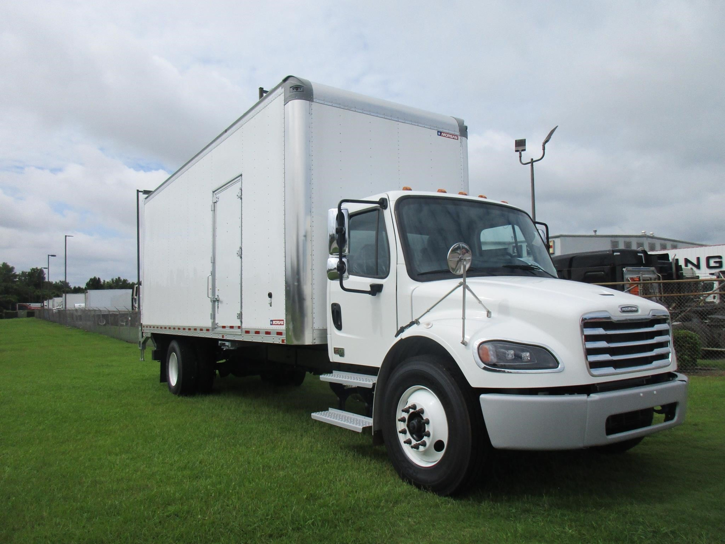 Freightliner M2 106 box truck side and front view showing cargo box and cab in white.
