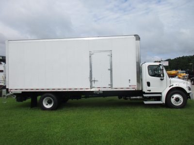 Freightliner M2 106 box truck side view showing cab and cargo box with side door and white paint