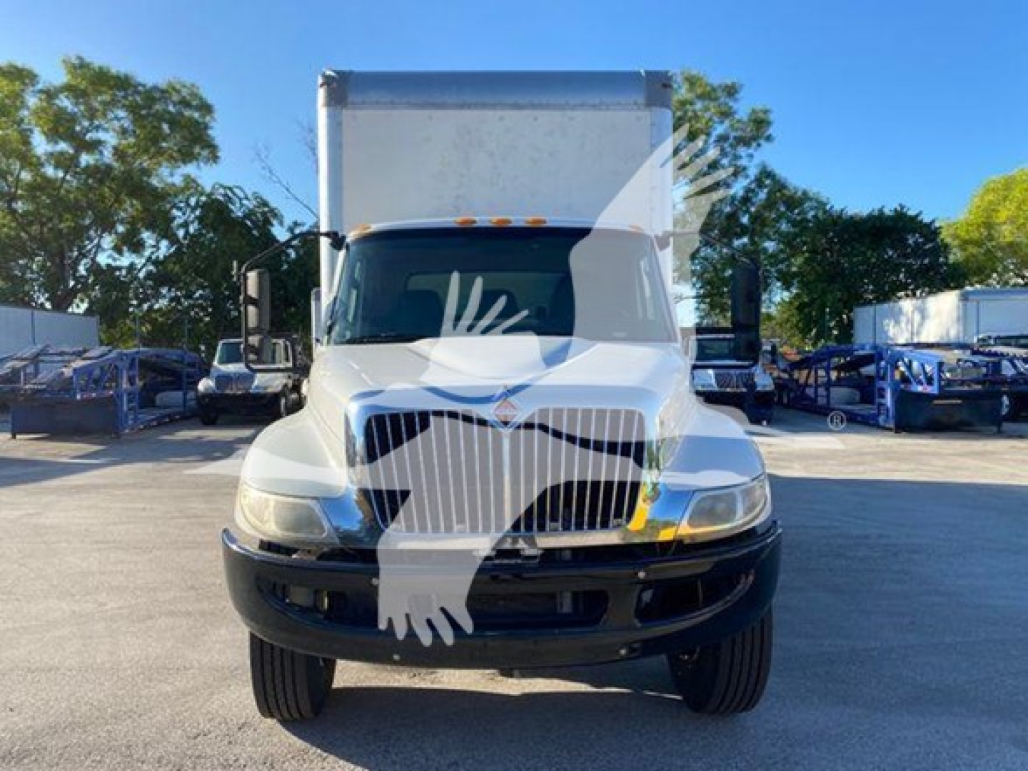 Truck front view of 2020 International MV box truck in a dealership lot, facing camera.