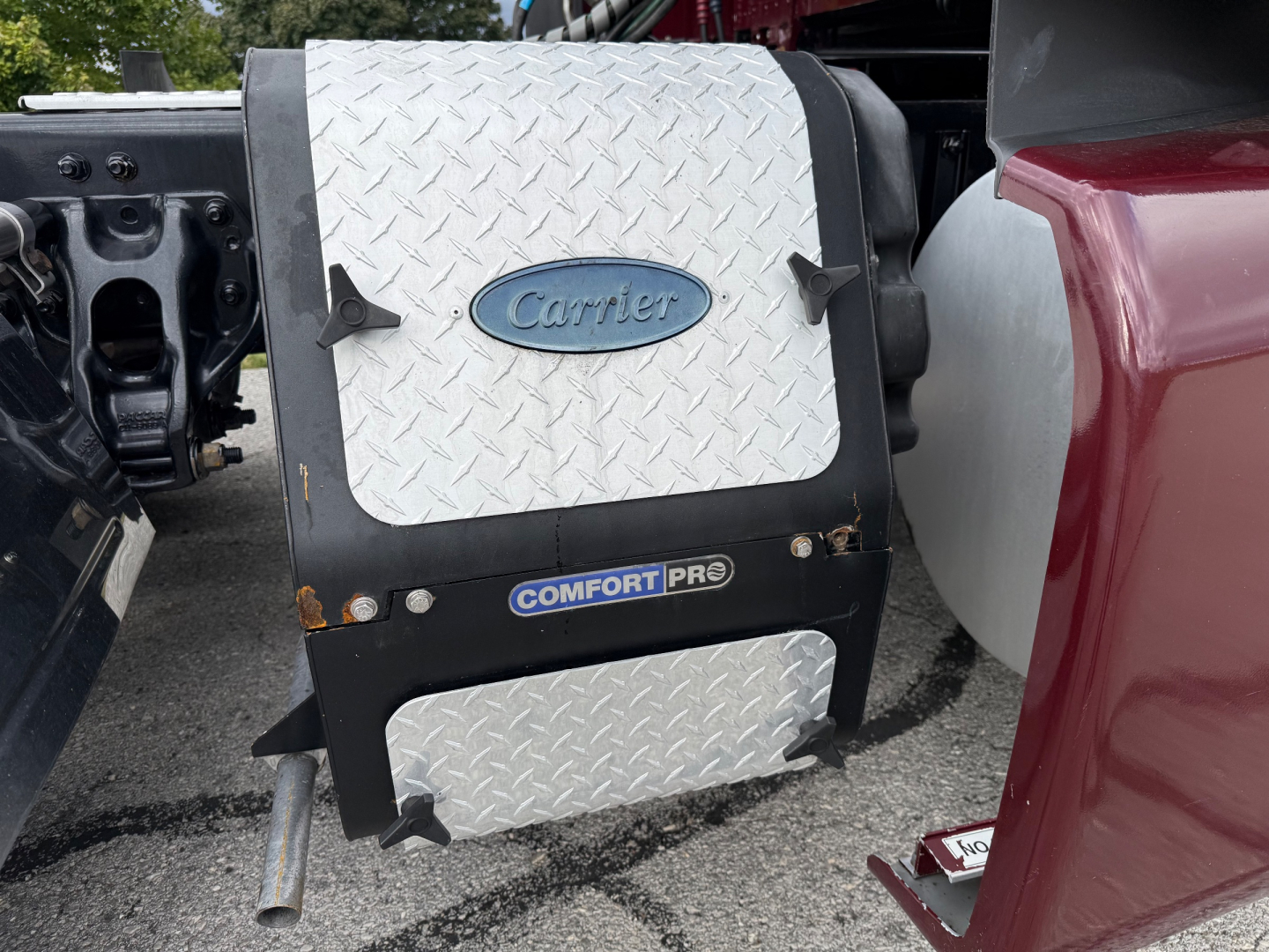 Kenworth T680 engine bay area with diamond plate toolbox showing 'Cheet' logo and 'Comfort Pro' label.
