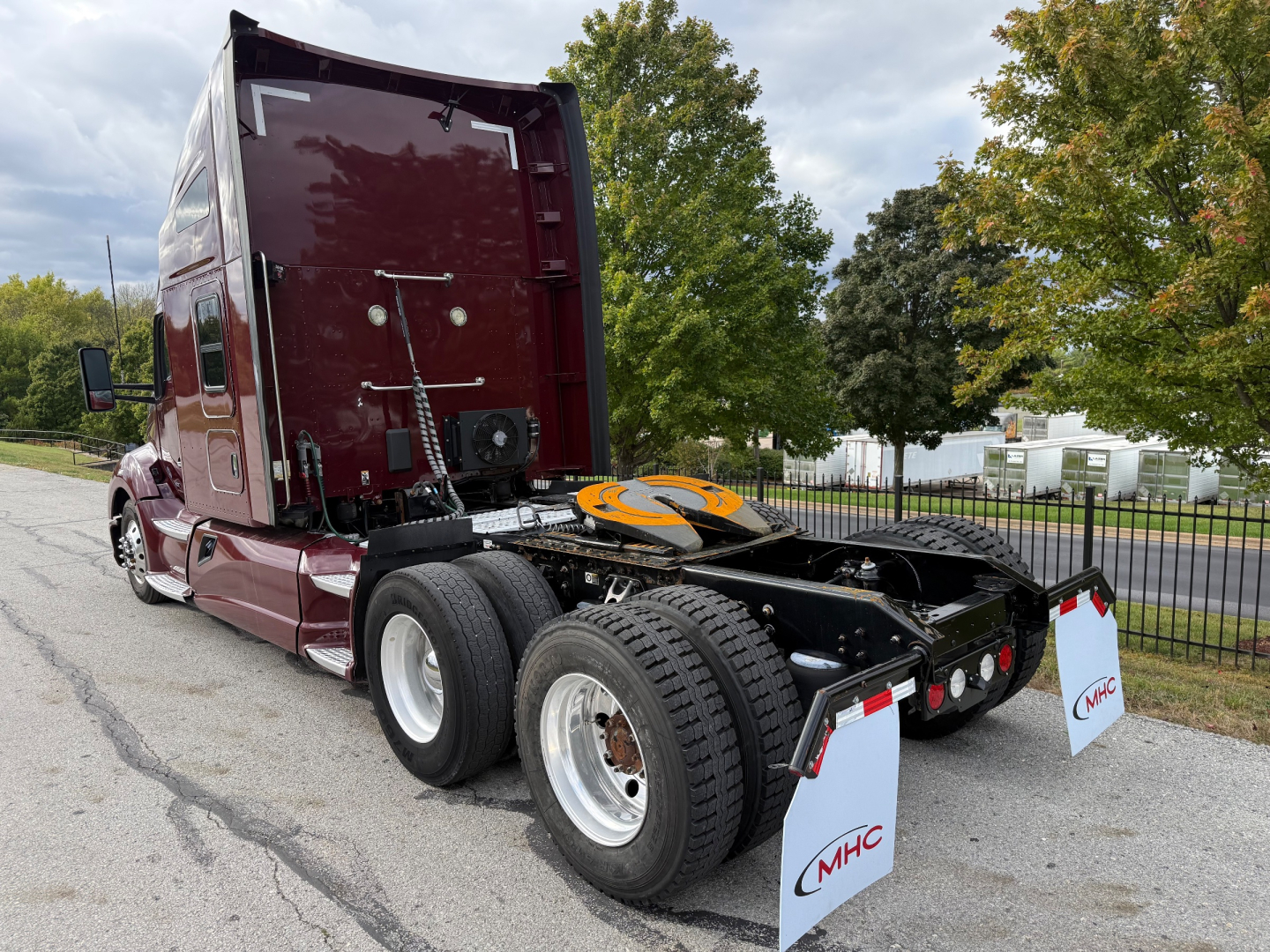 Kenworth T680 conventional sleeper truck chassis and rear view showing dual rear axles and fifth wheel coupling.