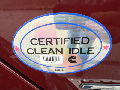 Kenworth T680 badge area with Certified Clean Idle sticker and holographic seal.