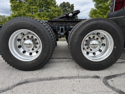 Kenworth T680 wheels and dual rear axles showing Rimtec tires and chrome hubcaps.