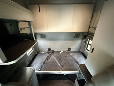 Kenworth T680 sleeper cab interior showing cargo bed/bed area and surrounding panels.