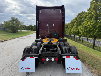 Kenworth T680 rear view showing chassis and fifth wheel with mud flaps and dual rear axles.