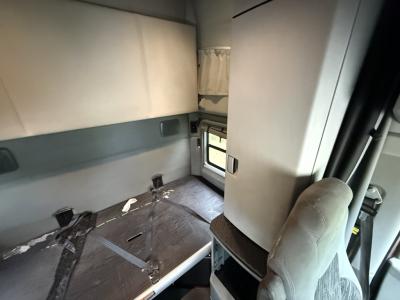 Kenworth T680 sleeper cab interior showing bunk area with seat and window