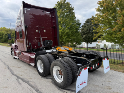Kenworth T680 conventional sleeper truck chassis and rear view showing dual rear axles and fifth wheel coupling.