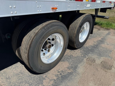 Dual rear trailer wheels on a Utility 3000R trailer showing Michelin tires and silver rims with black rubber treads.