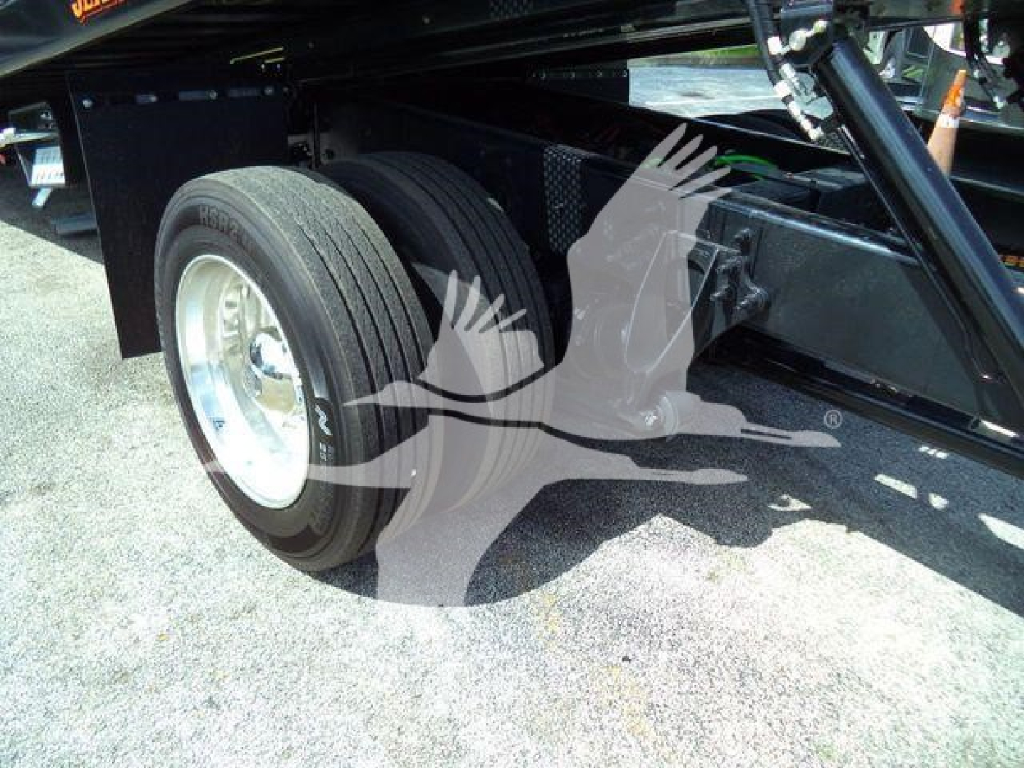 Trucks undercarriage showing rear dual wheels and suspension of a 2027 International MV rollback truck with black chassis