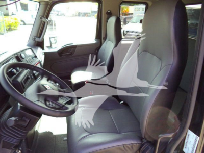 Truck cab interior showing driver and passenger seats with steering wheel and dashboard of a 2027 International MV rollback truck.