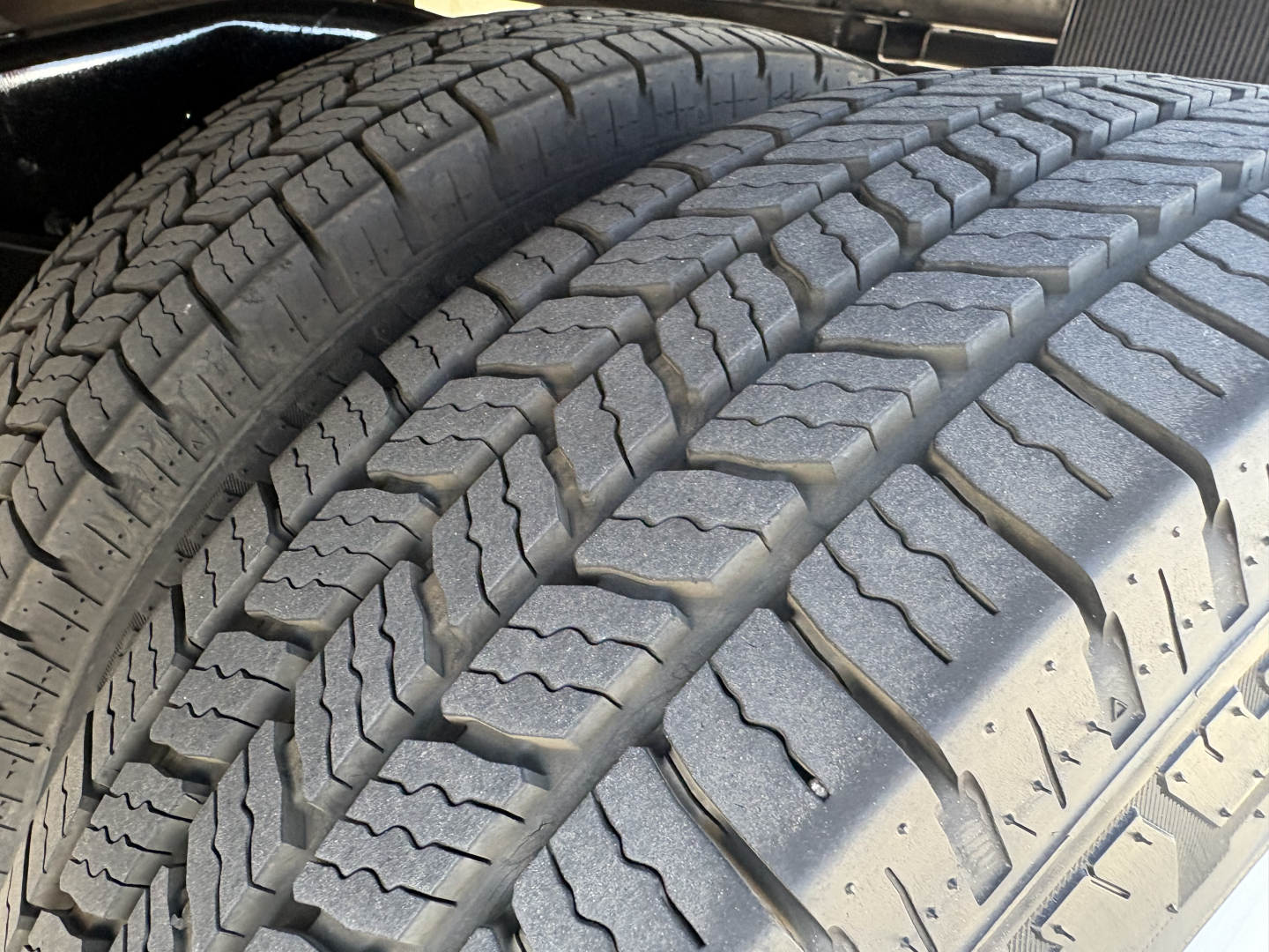 Tire tread close-up on a 2022 Ford E350 high cube cutaway showing dual rear tires and tread pattern.