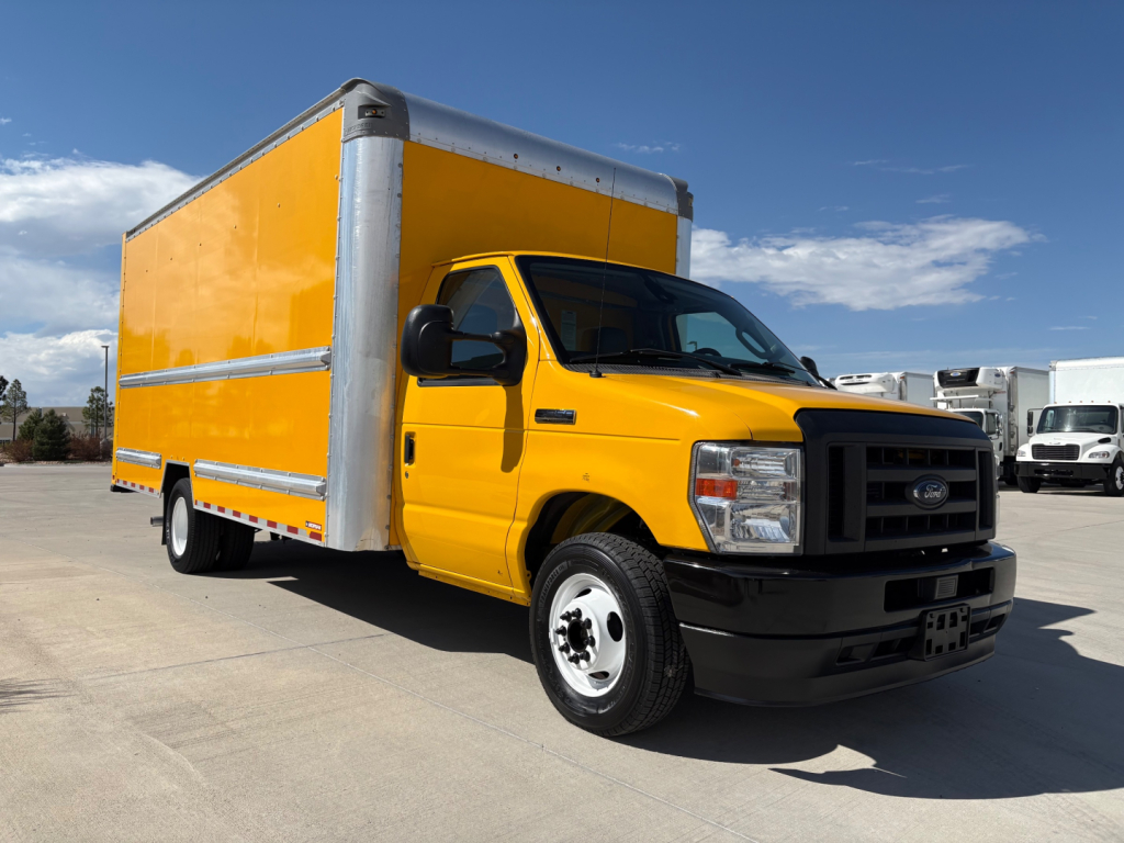 Truck showing a yellow 2022 Ford E350 box truck with cargo box on a sunny day.