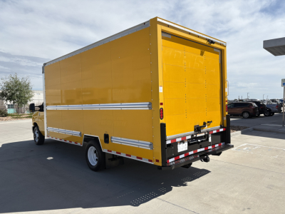 Ford E350 box truck rear view showing yellow cargo box with rear double doors and reflective striping.