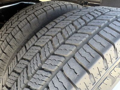 Tire tread close-up on a 2022 Ford E350 high cube cutaway showing dual rear tires and tread pattern.