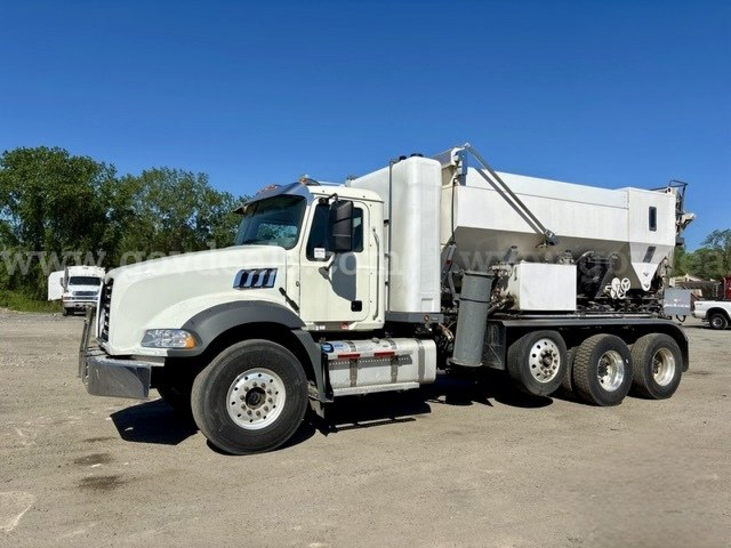 Truck side view showing 2019 Freightliner 114SD mixer with white cab and large mixer body. Visible text on truck includes none clearly legible; truck has New/Used listing context but no specific brand labels readable.