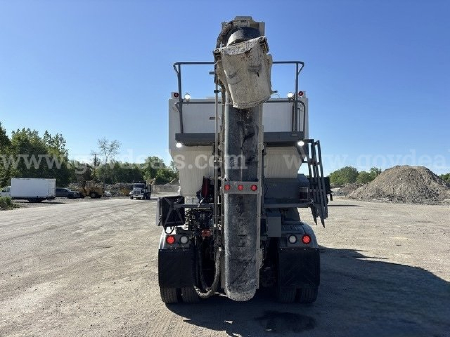 Rear view of a Freightliner 114SD mixer showing large chute and rear lights.