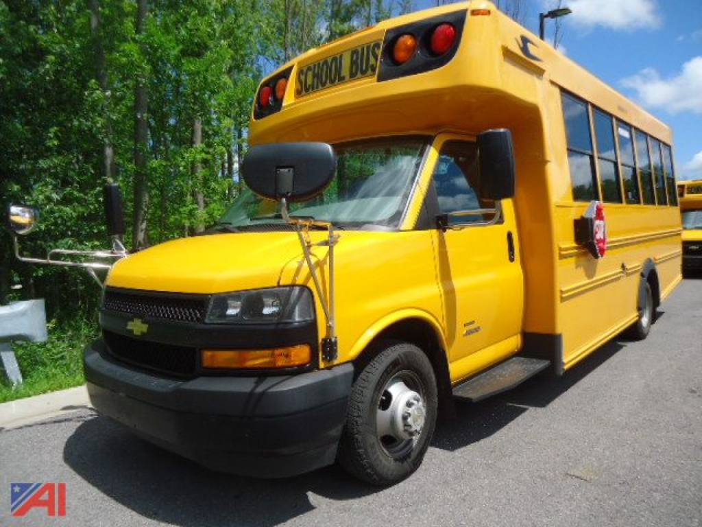2020 Chevrolet Express 4500 Micro Bird school bus side view showing bright yellow body, wheelchair lift area, and school bus signage
