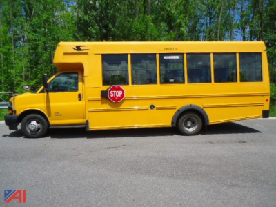 School bus side view showing a yellow 2020 Chevrolet Express 4500 Micro Bird with stop sign extended, black trim, and multiple windows.